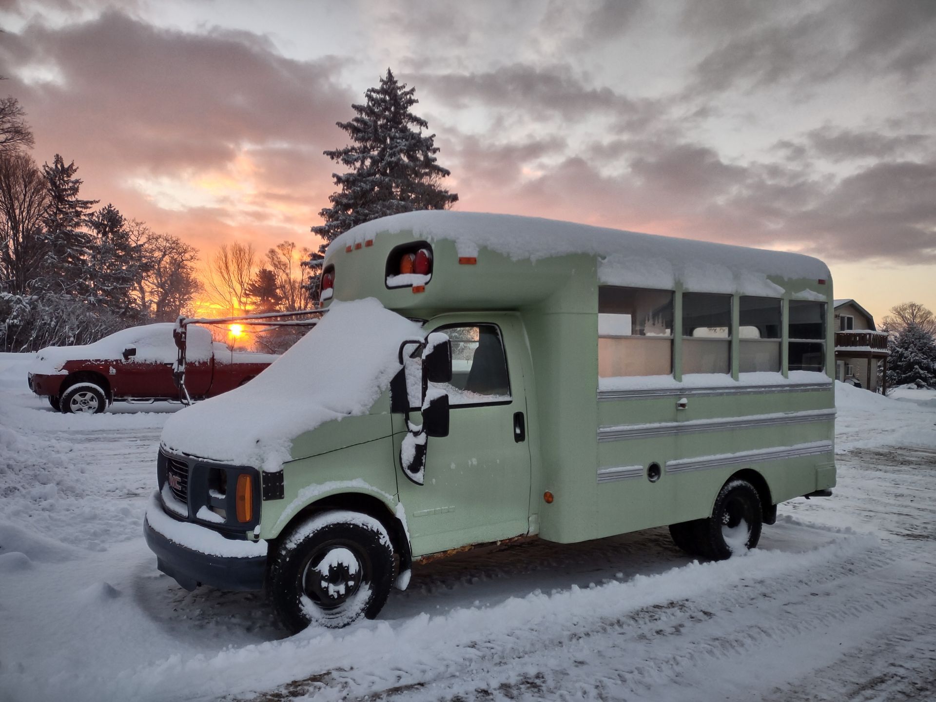 Skoolie in the snow being converted into camper.