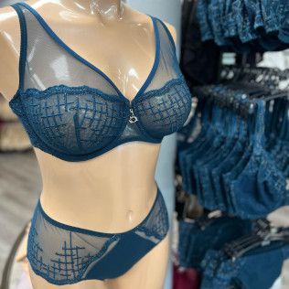 Blue lace bra and matching panties displayed on a mannequin in a lingerie store