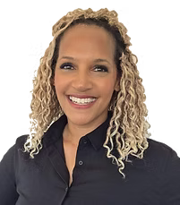 Dr. Shara Downey - Smiling person with curly blonde hair wearing a black collared shirt against a white background