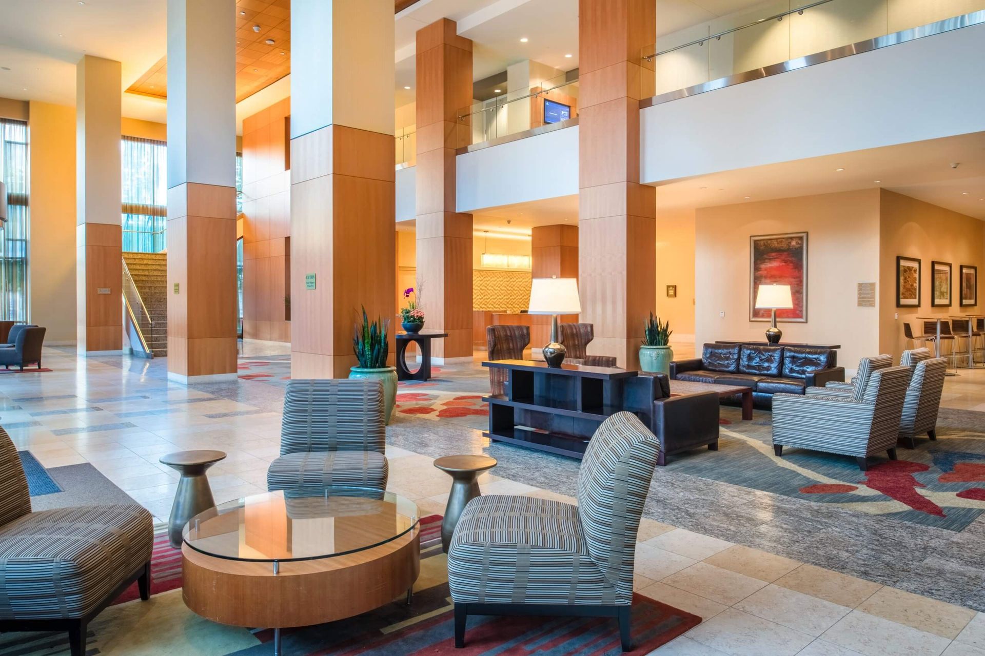 A hotel lobby with a lot of chairs and tables