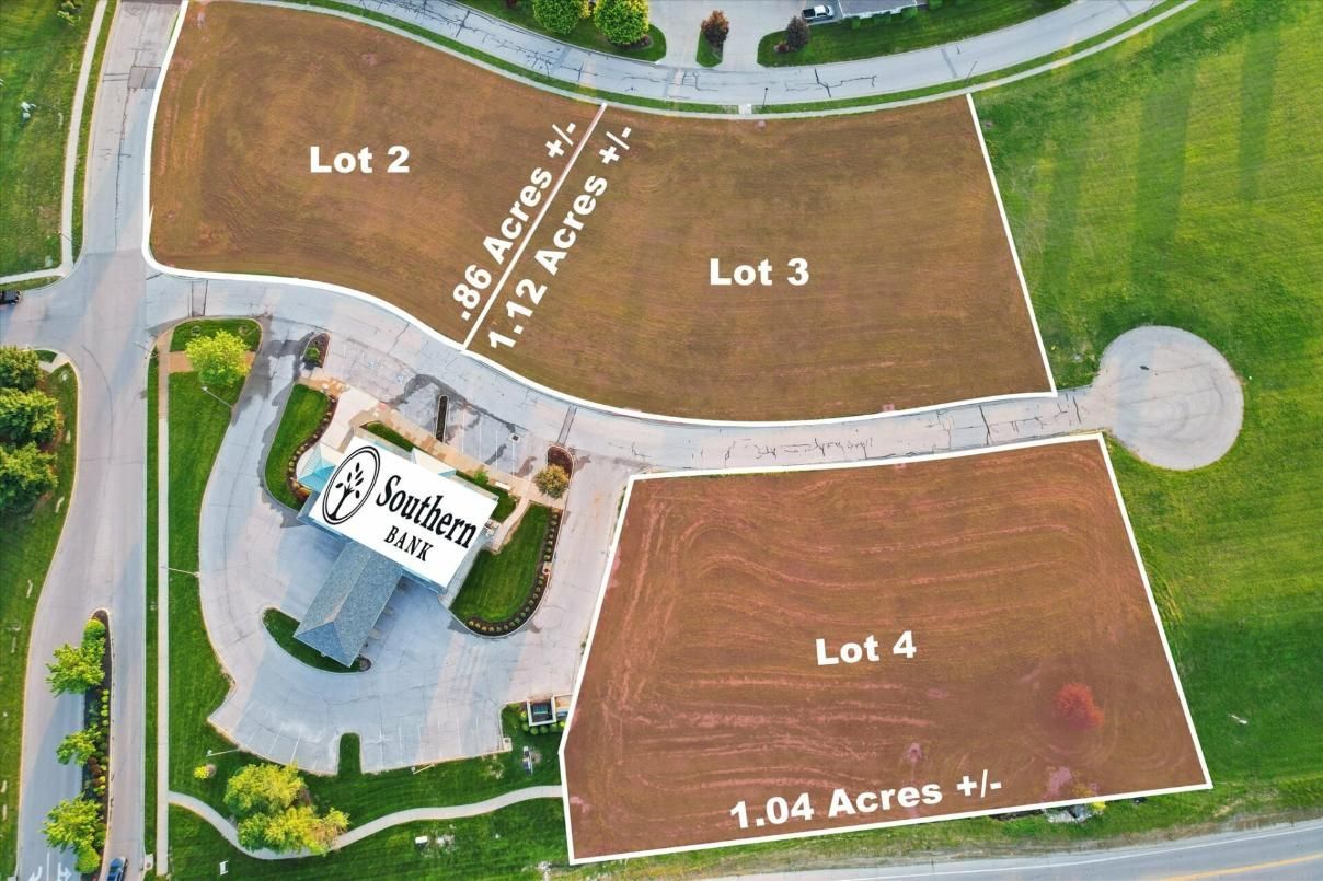 Aerial view of a vacant lot plan with labeled parcels, roads, and a circular cul-de-sac.