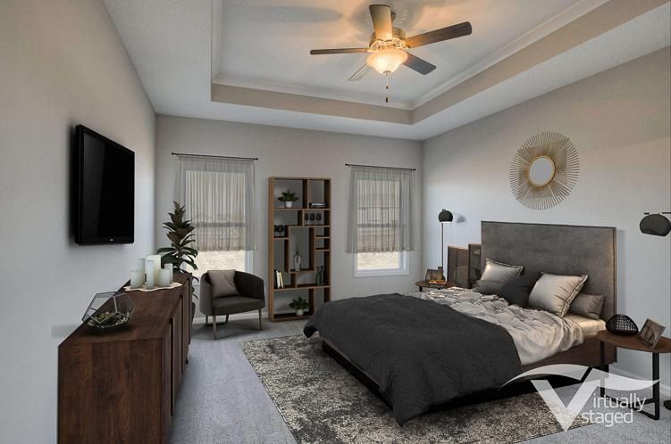 Modern bedroom with gray bed, wall-mounted TV, and ceiling fan in a bright, neutral-toned room
