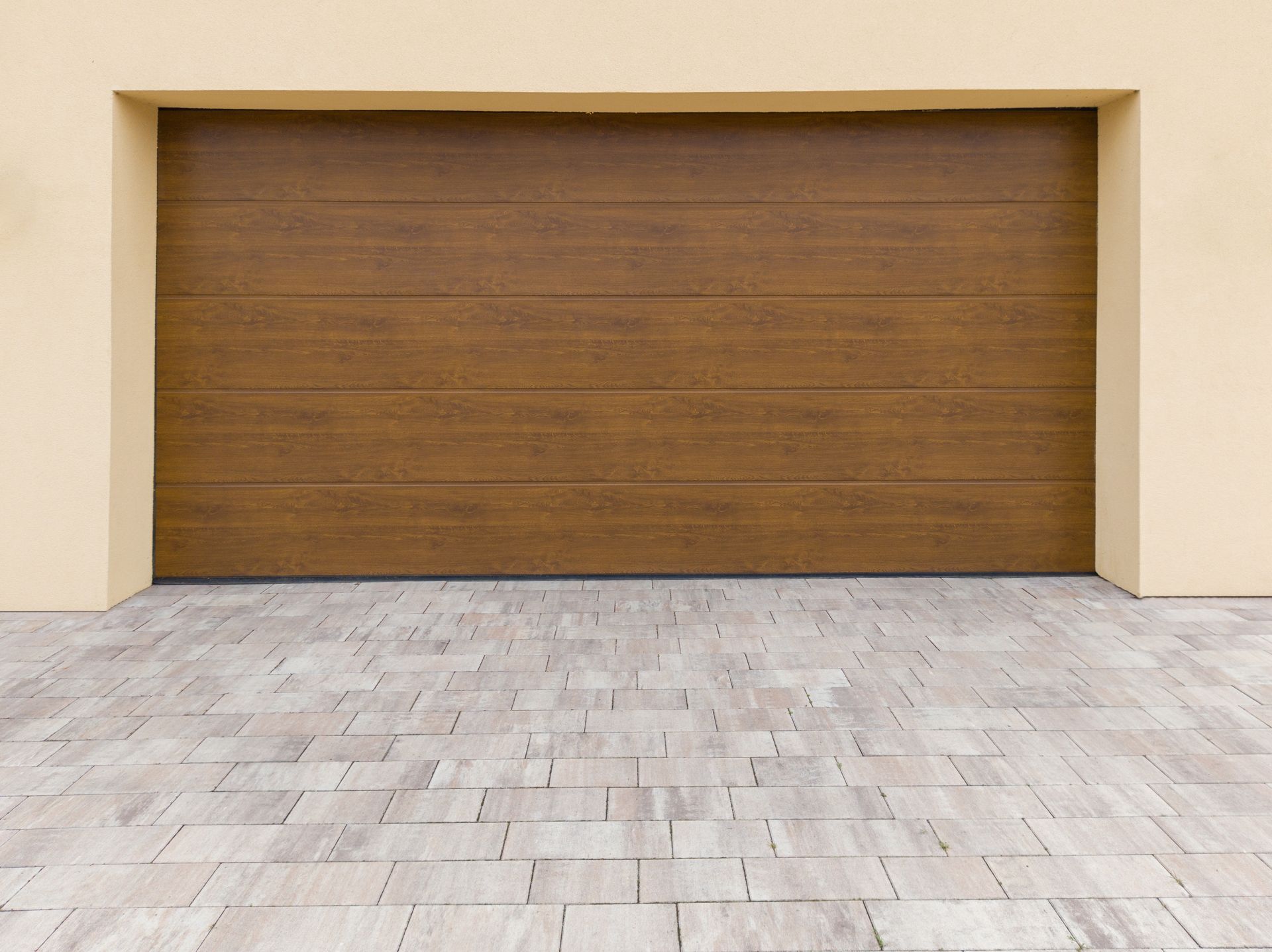 A person is opening a garage door with a remote control.