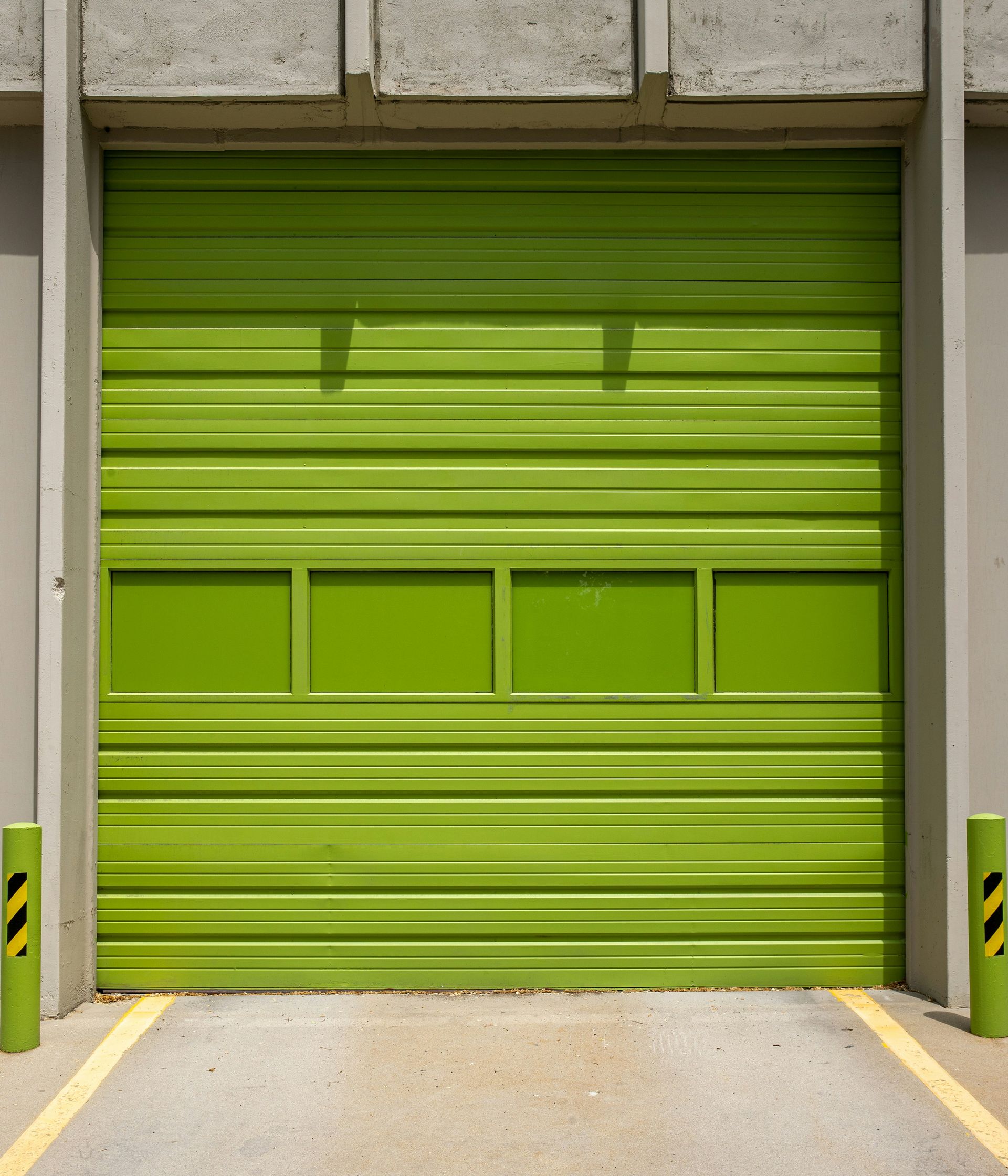 A person is opening a garage door with a remote control.