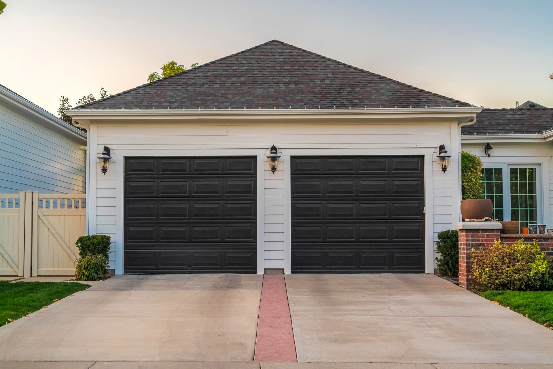 A person is opening a garage door with a remote control.