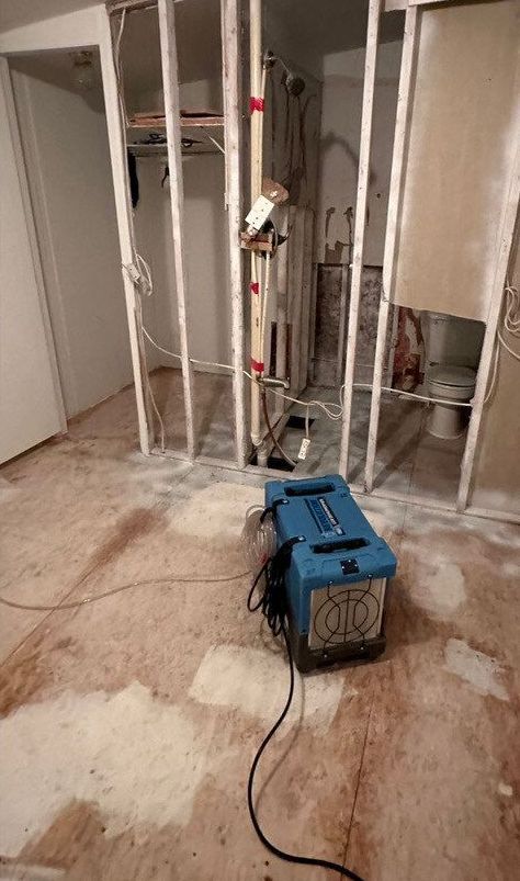 A blue machine is sitting on the floor in a room.