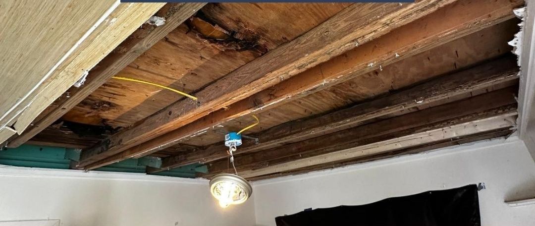 A room with a wooden ceiling and a light hanging from it.