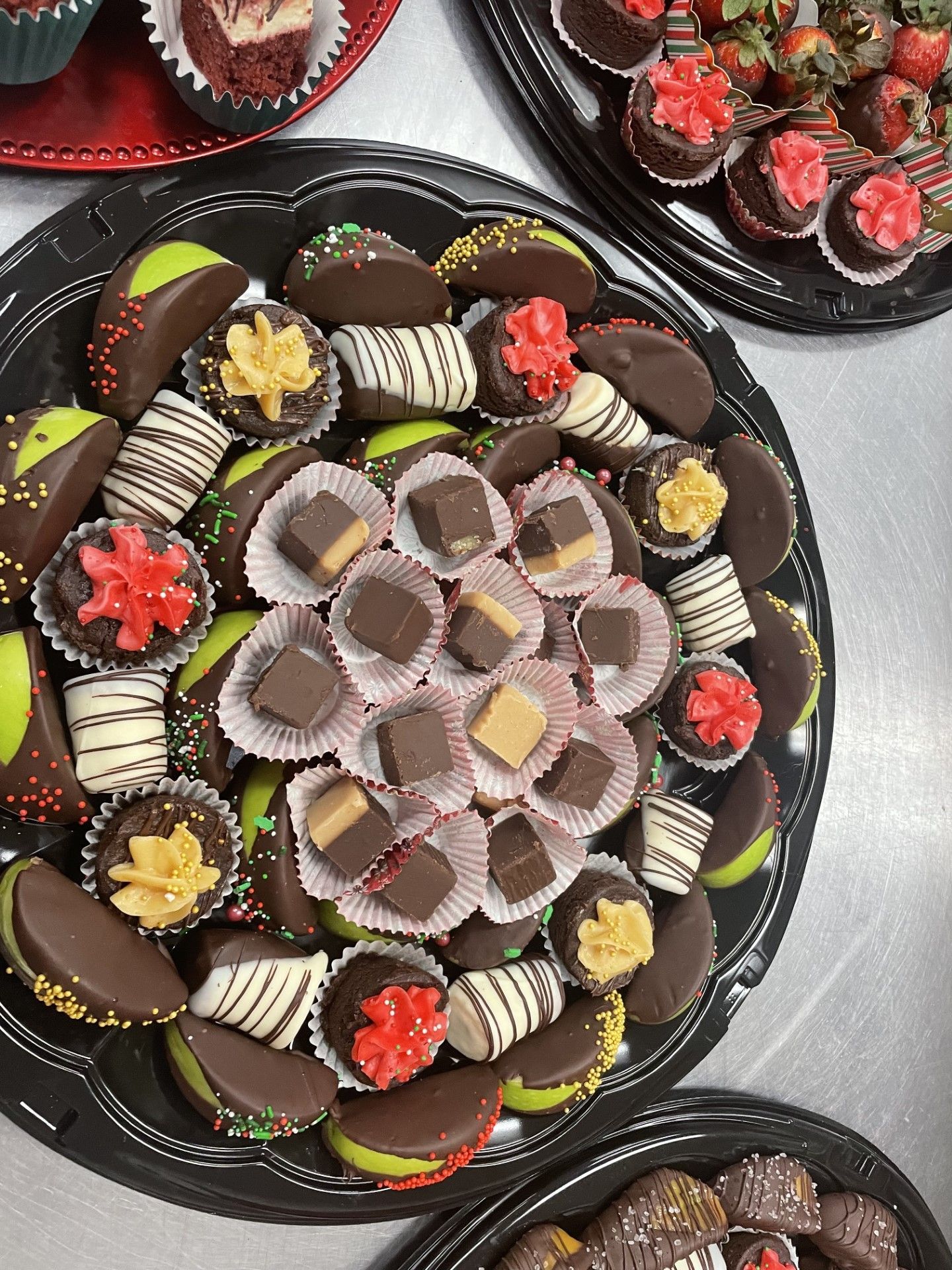 A tray of chocolates and strawberries on a table