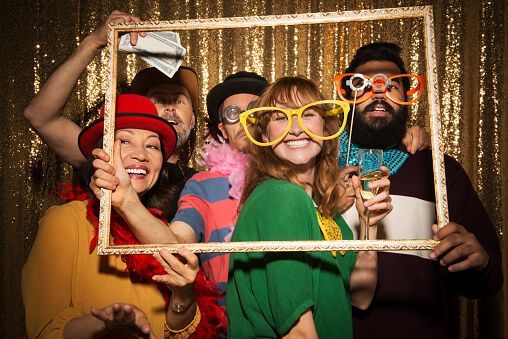 group of preople using a photobooth in an event