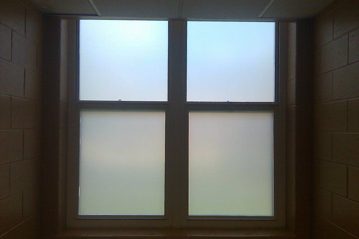 A window with frosted glass in a dark room.