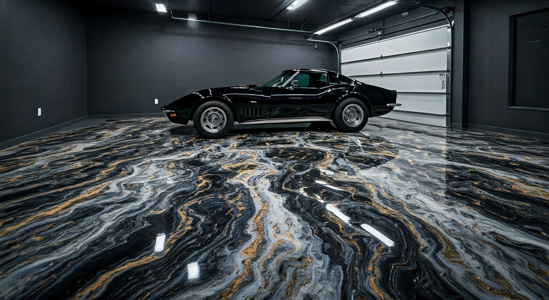 Black Corvette in a sleek, black garage with a marbled epoxy floor.
