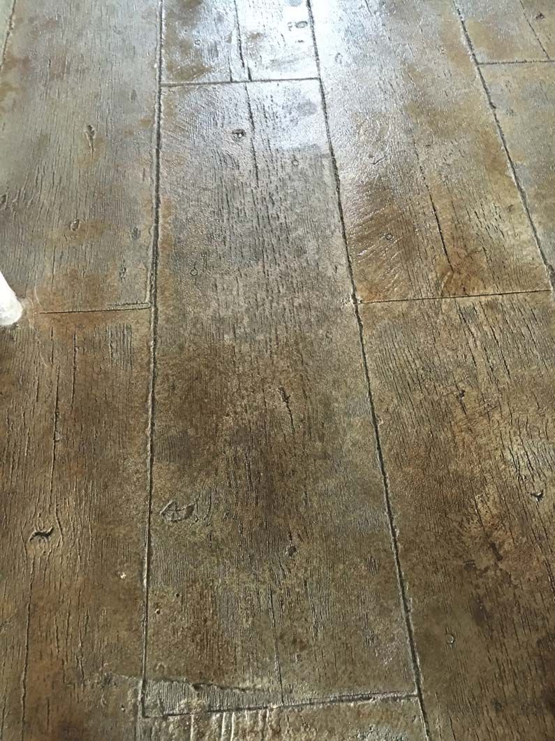 Wood floor with a distressed finish in shades of brown and tan.