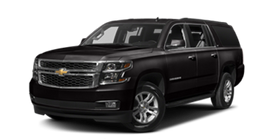 A black Chevrolet Suburban SUV parked at an angle against a white background.