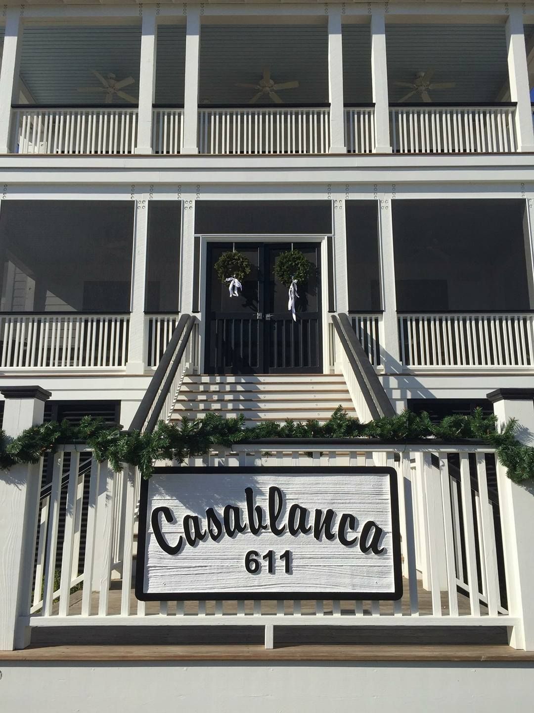 White building facade with central stairs and a sign reading “Constance 611” at the entrance