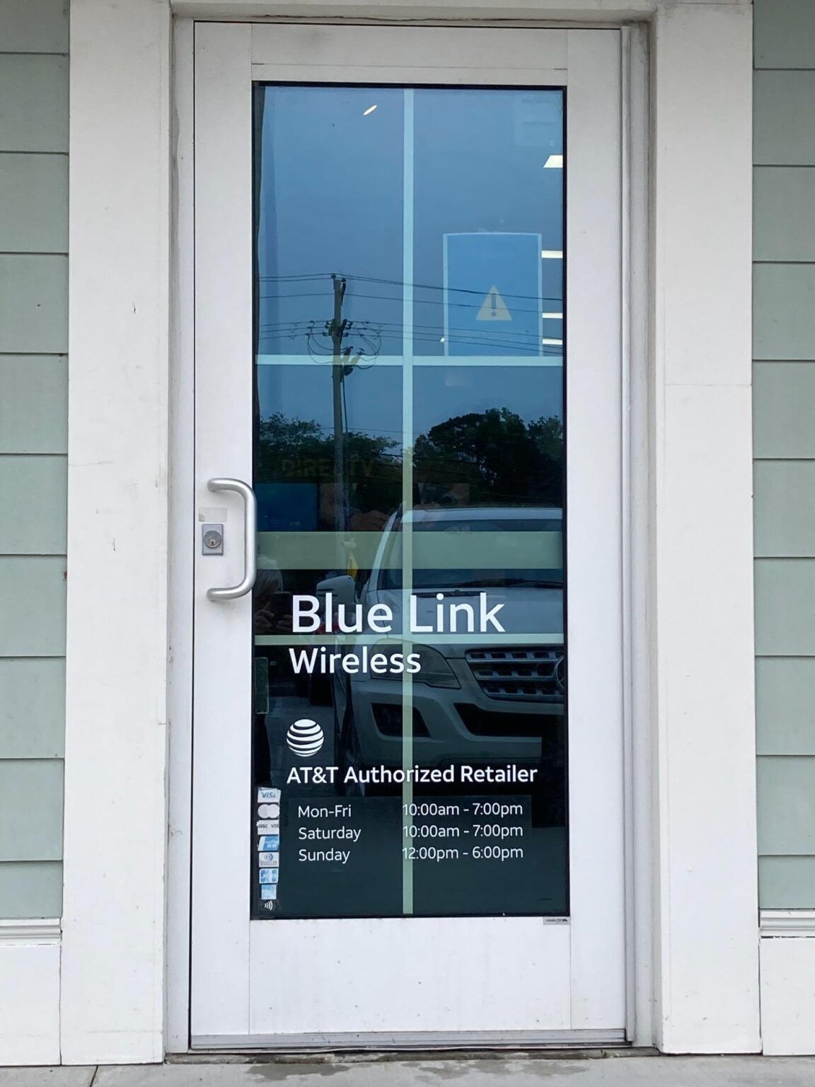 Blue Link Wireless storefront door with AT&T Authorized Retailer signage in white and blue
