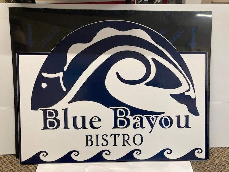 Blue Bayou Bistro logo with a navy wave and white text on a black-and-white sign