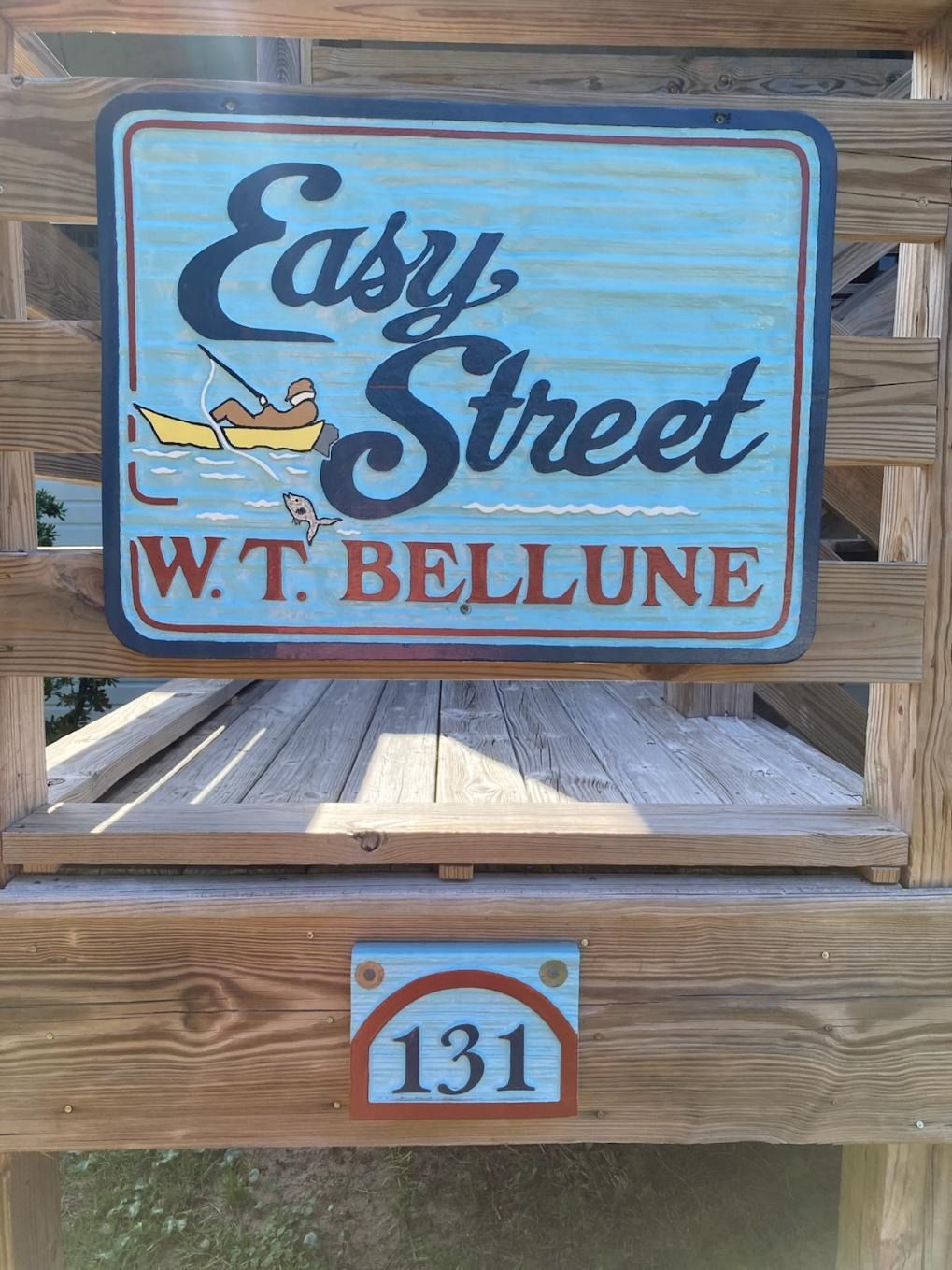 Sign for Easy Street W.T. Bellune with room 131 on a wooden railing