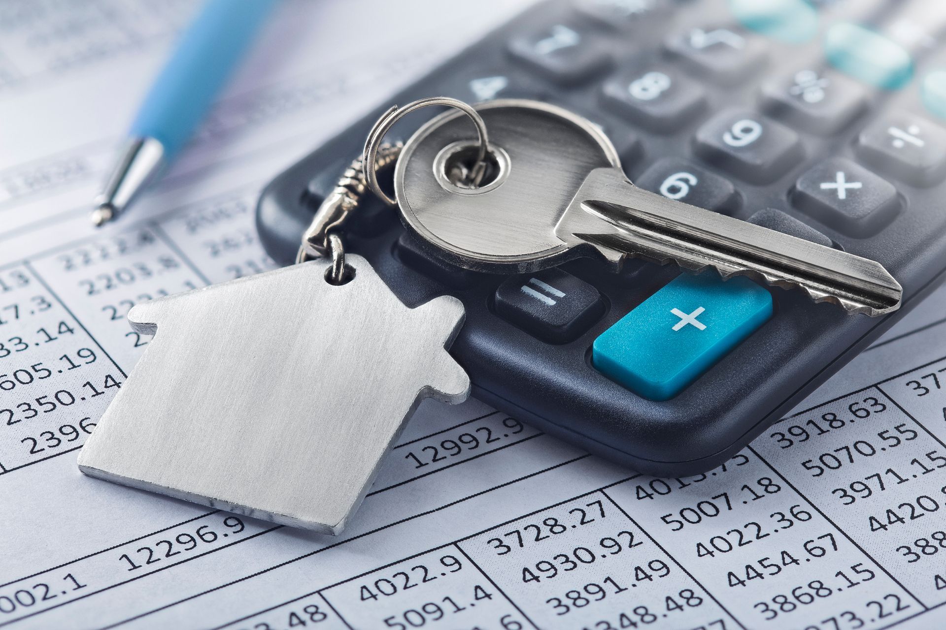A calculator with a key on top of it