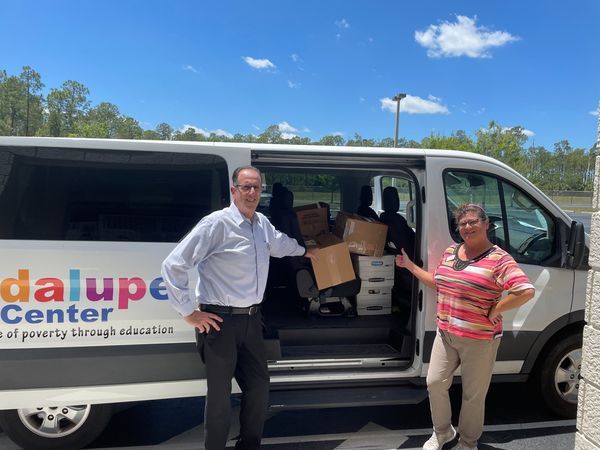 Two people beside a van labeled 