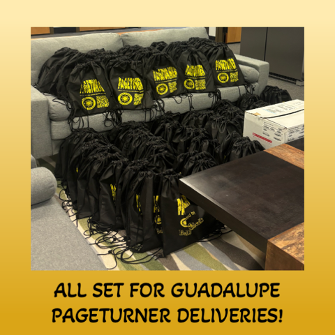 Black drawstring bags with yellow logos stacked on a couch and floor. Preparing for deliveries.