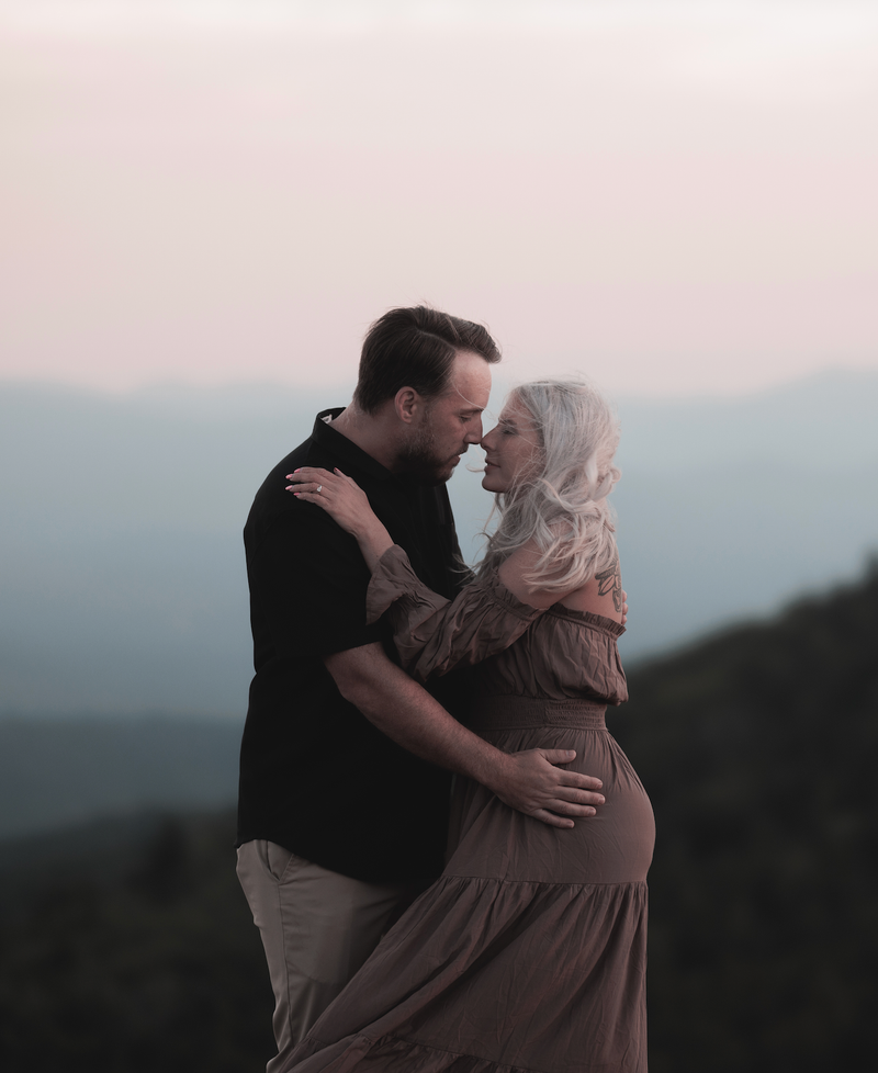 Brandon and Grace embracing at sunset