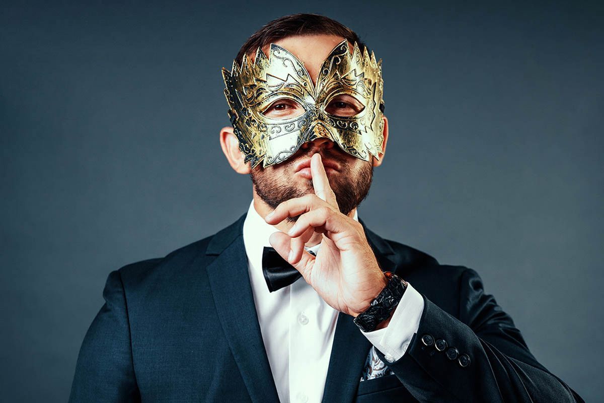 man wearing mask hushing