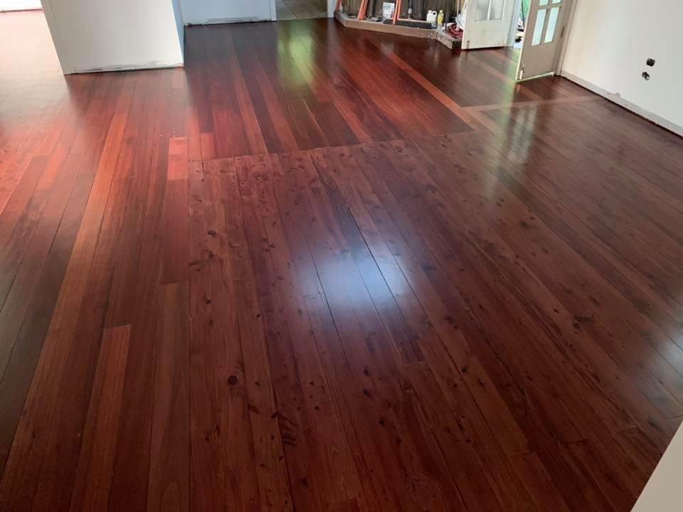 Polished, Reddish-brown Hardwood Floor Reflecting Light — Custom Floor Sanding In Somersby, NSW