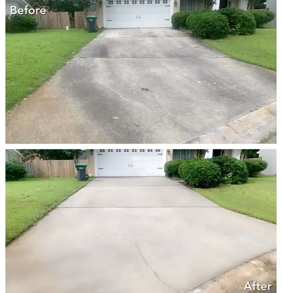 Driveway cleaned with pressure washer; before and after photos show stained concrete transformed to a lighter gray.