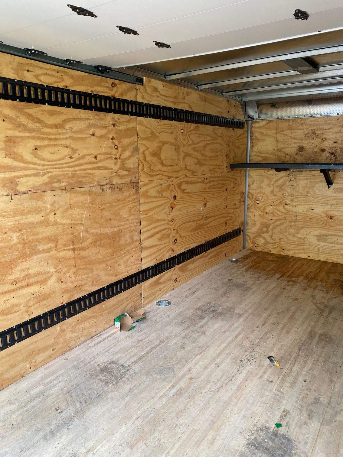 the inside of a truck with wooden walls and a wooden floor .