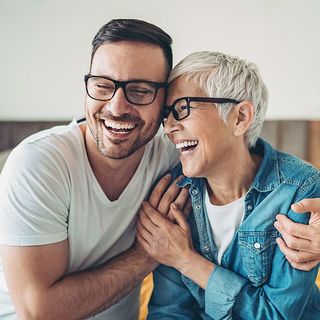 Smiling mother and her adult son