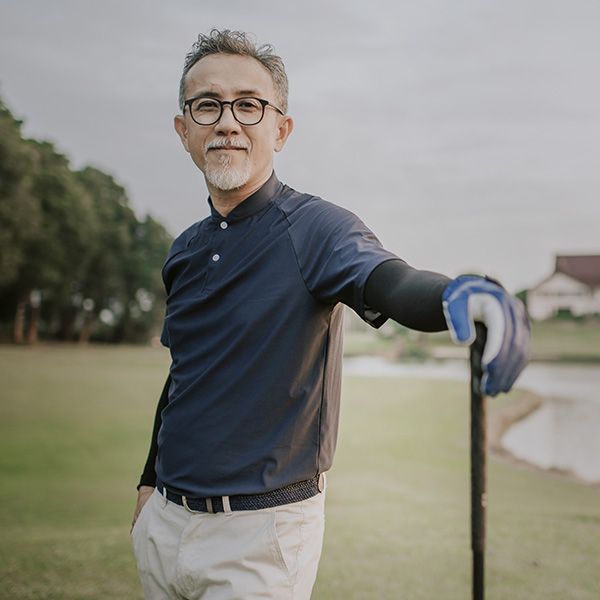 Senior man golfer standing with his golf club driver in the golf course