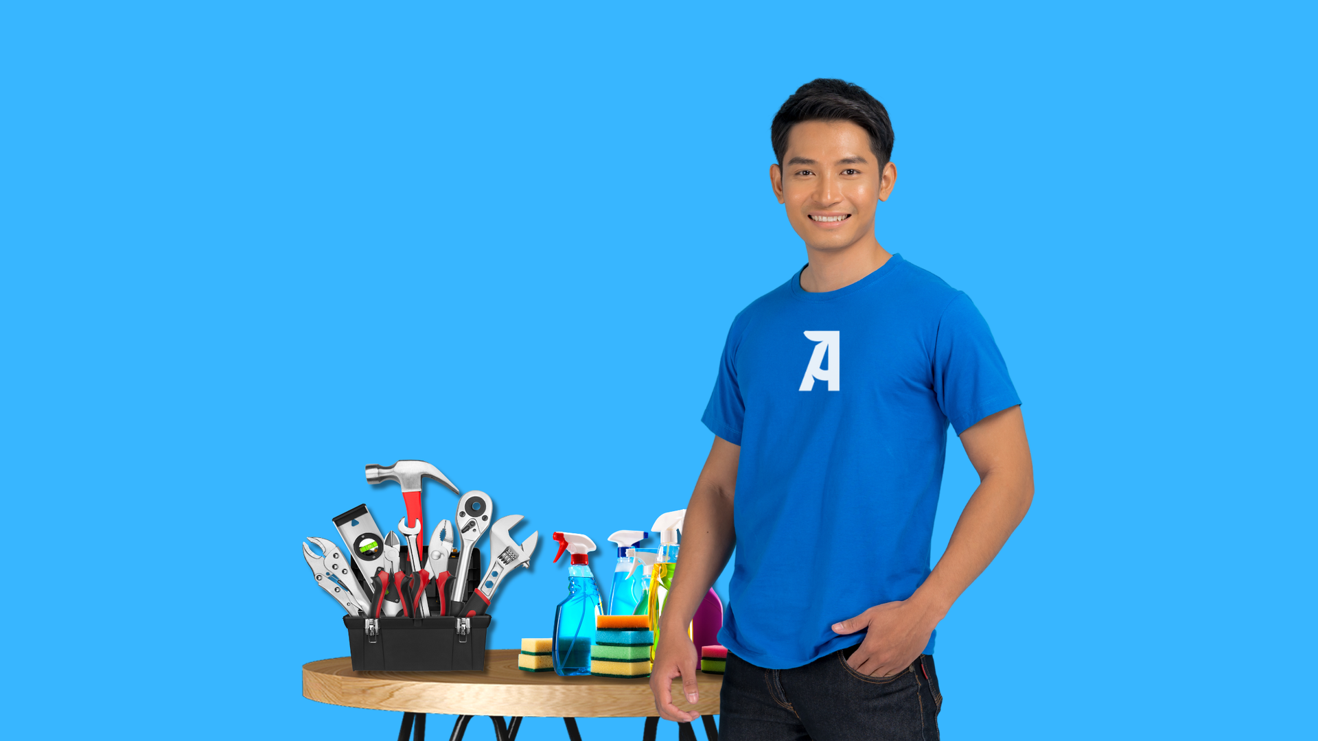 A person wearing a blue shirt stands next to a wooden table with tools and cleaning supplies against a blue background.