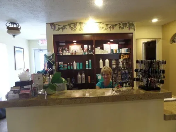 A woman stands behind a counter in a store