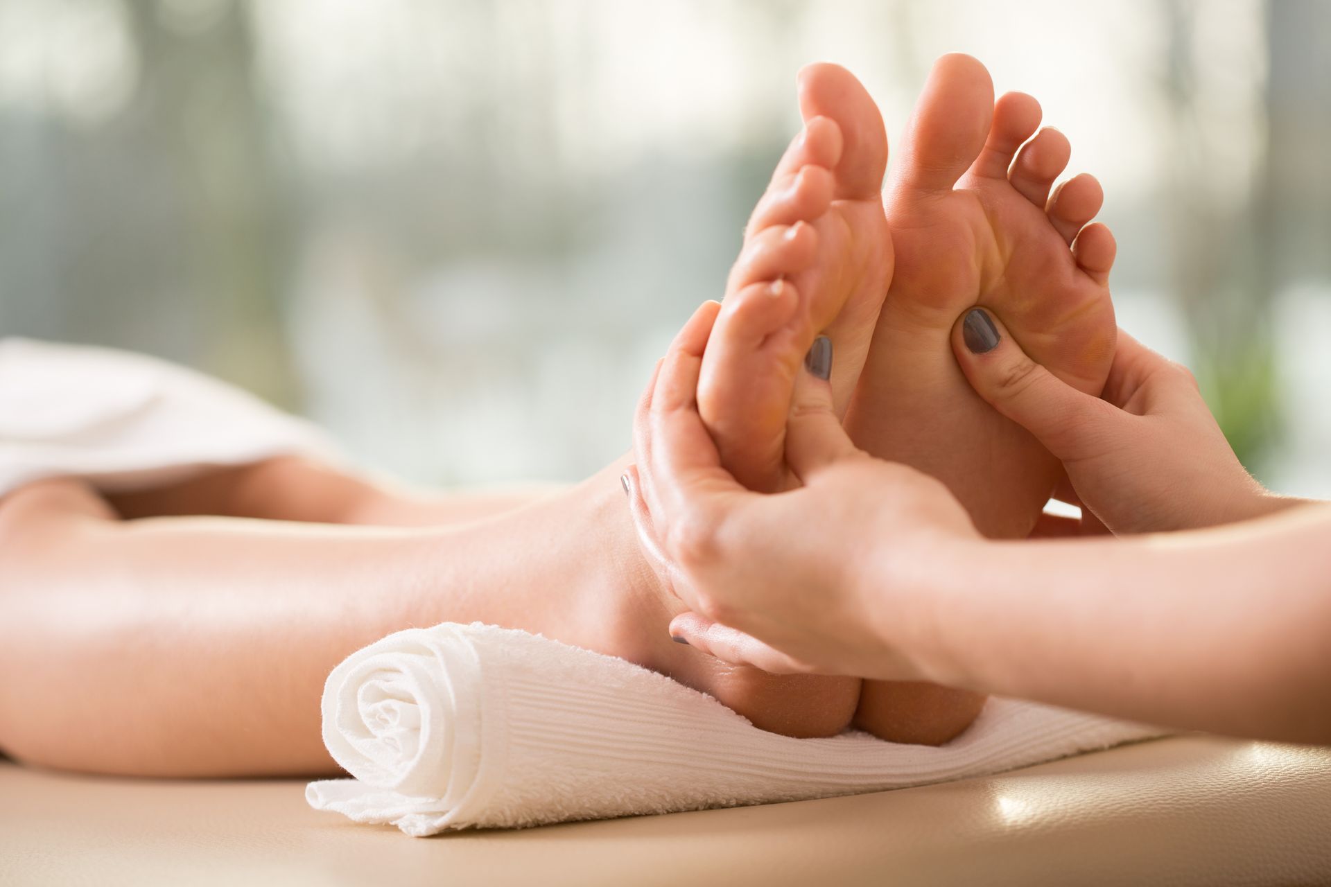 A woman is getting a foot massage at a spa.