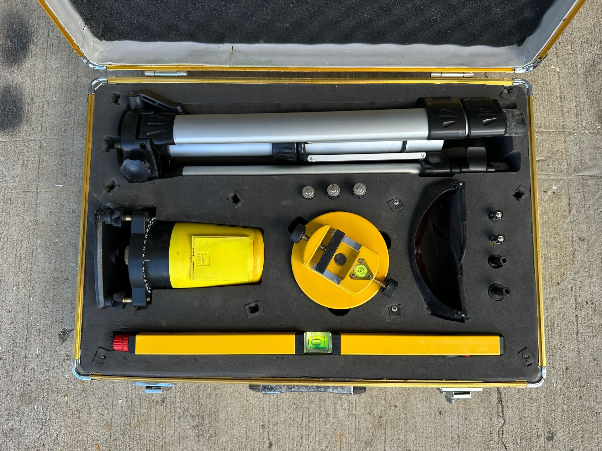 Open toolbox with yellow and black tools arranged inside a foam-lined case.