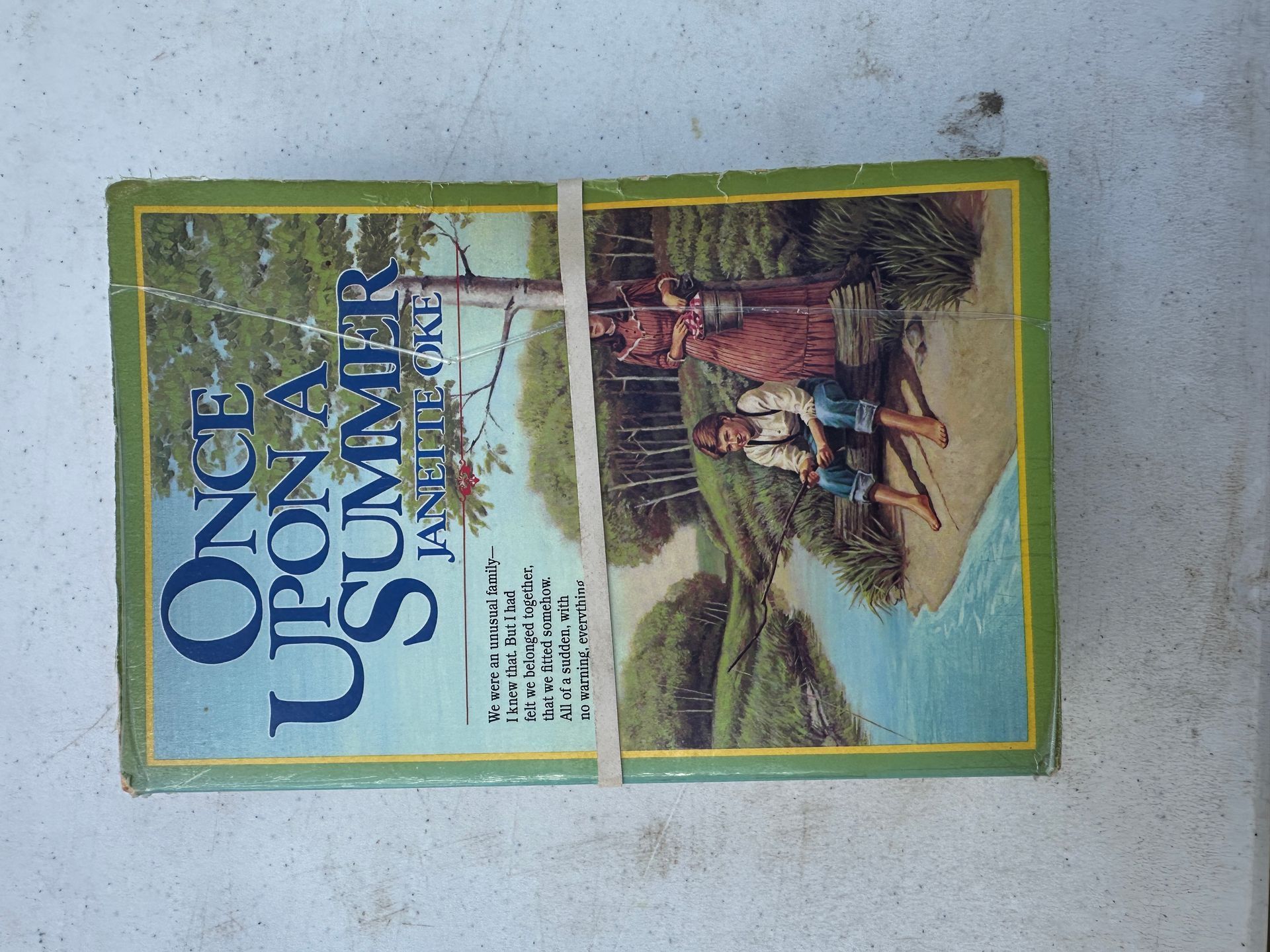 Rotated magazine cover with green border, blue title text, and a photo of people in a rural scene