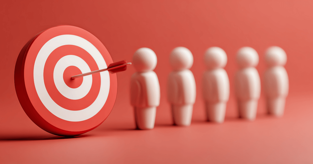 Red target with dart hitting bullseye beside a row of small white figures on a pink background
