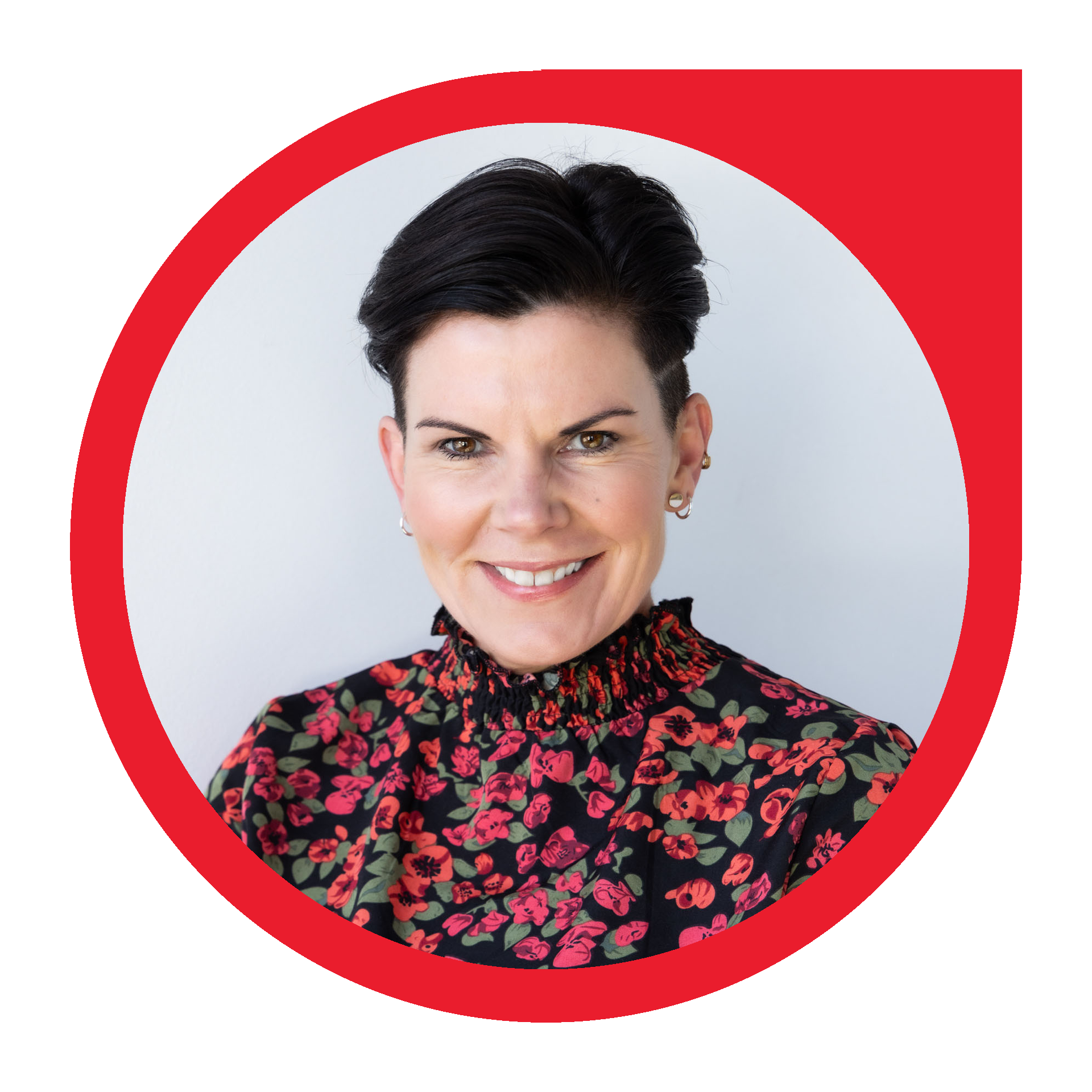 Woman with short dark hair smiles, wearing floral top, in red circle.