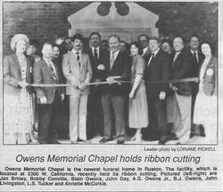 Ribbon-cutting at Owens Memorial Chapel with a group of people standing in front of the building.