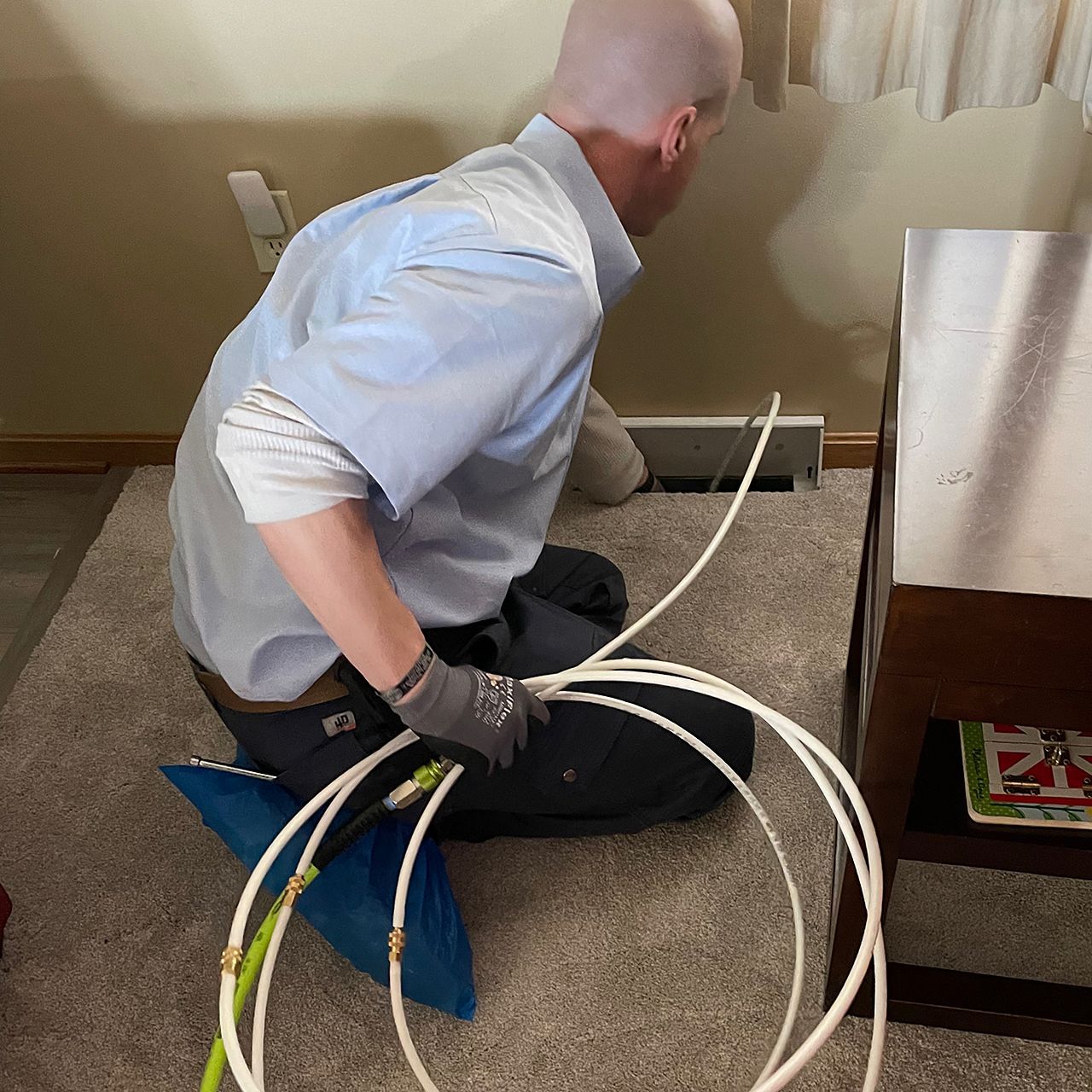 Gorjanc Home Services technician uses high-pressure air and rotary brushes