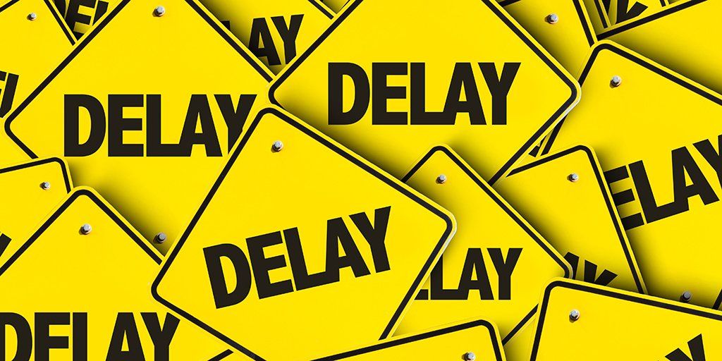 A bunch of yellow signs with the word DELAY on them