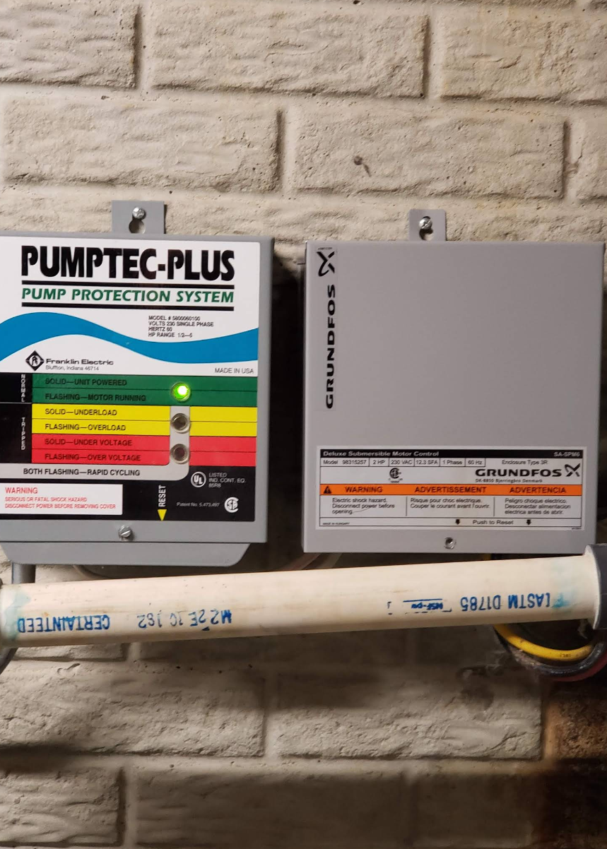 Pumptec-Plus pump protection system and gray control box mounted on a brick wall.