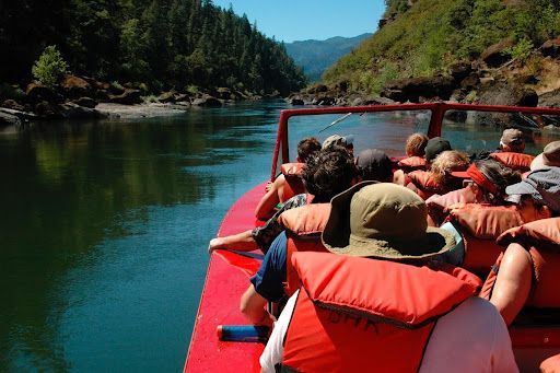 Passengers aboard a Jerry's Rogue Jets boat travel through the rugged canyon of the Wild and Scenic