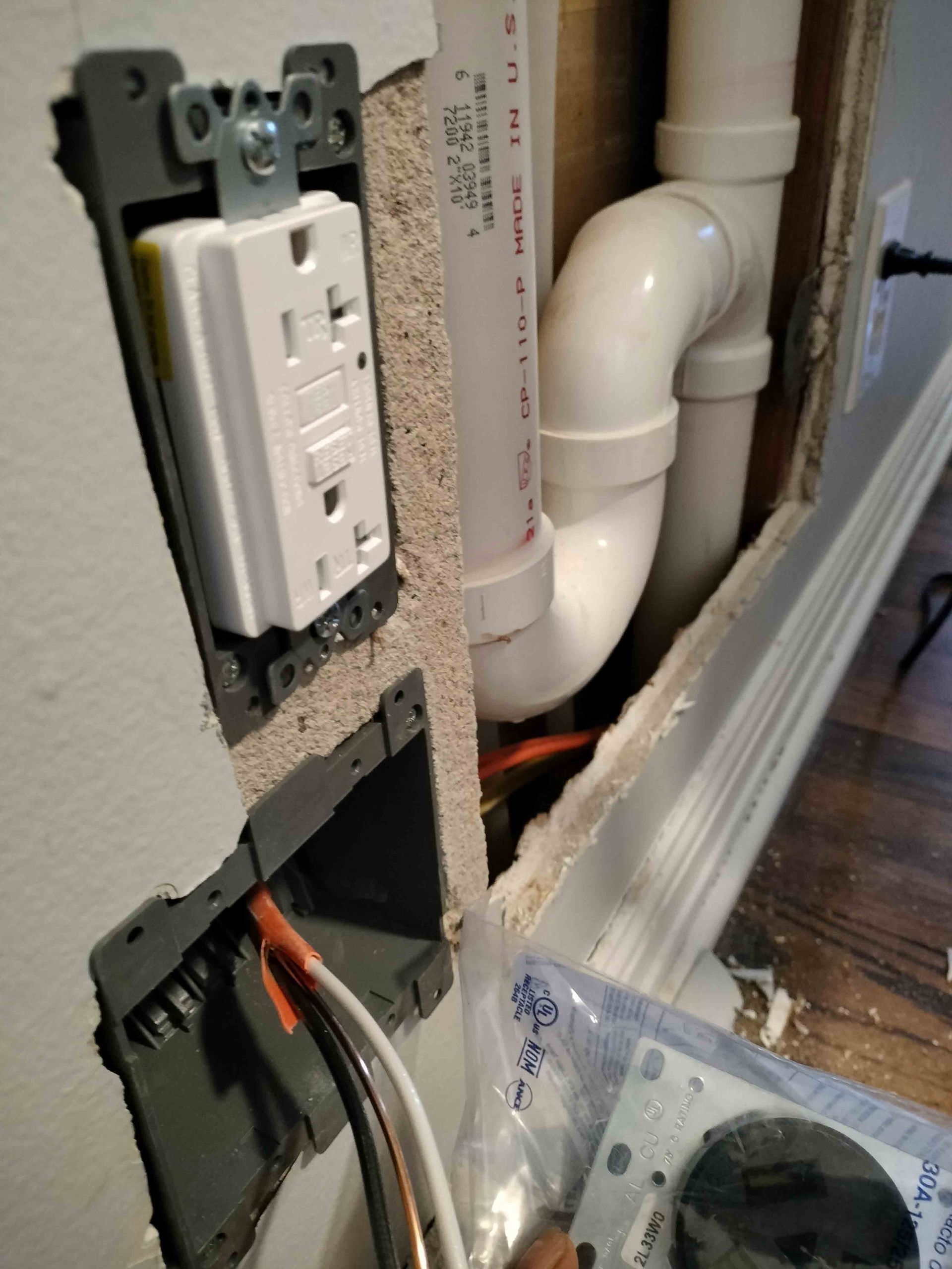 White Electrical Outlet Is Plugged Into A Wall — Knoxville, TN — DABZ CO LLC Electrical & Building Contractors White Electrical Outlet Is Plugged Into A Wall — Knoxville, TN — DABZ CO LLC Electrical & Building Contractors