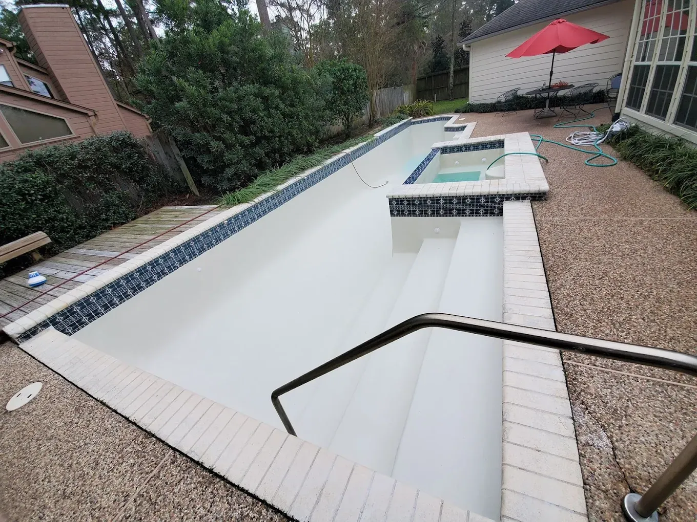 A large house with a large swimming pool in front of it