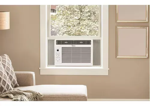 Sala de estar con un aire acondicionado de ventana ubicado en el centro, debajo de una ventana luminosa.