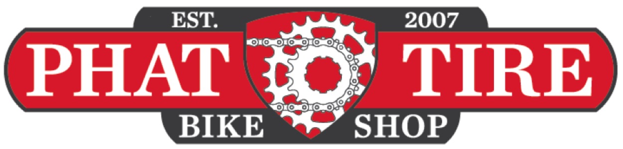 A red sign that says phat tire bike shop