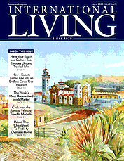 The cover of a magazine called international living with a painting of a city on it.