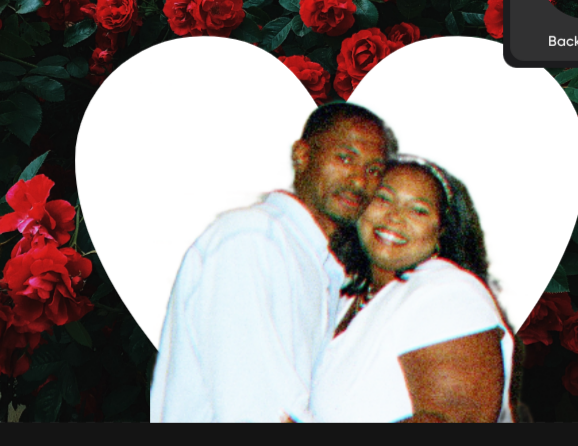 A man and woman are posing for a picture with a heart in the background