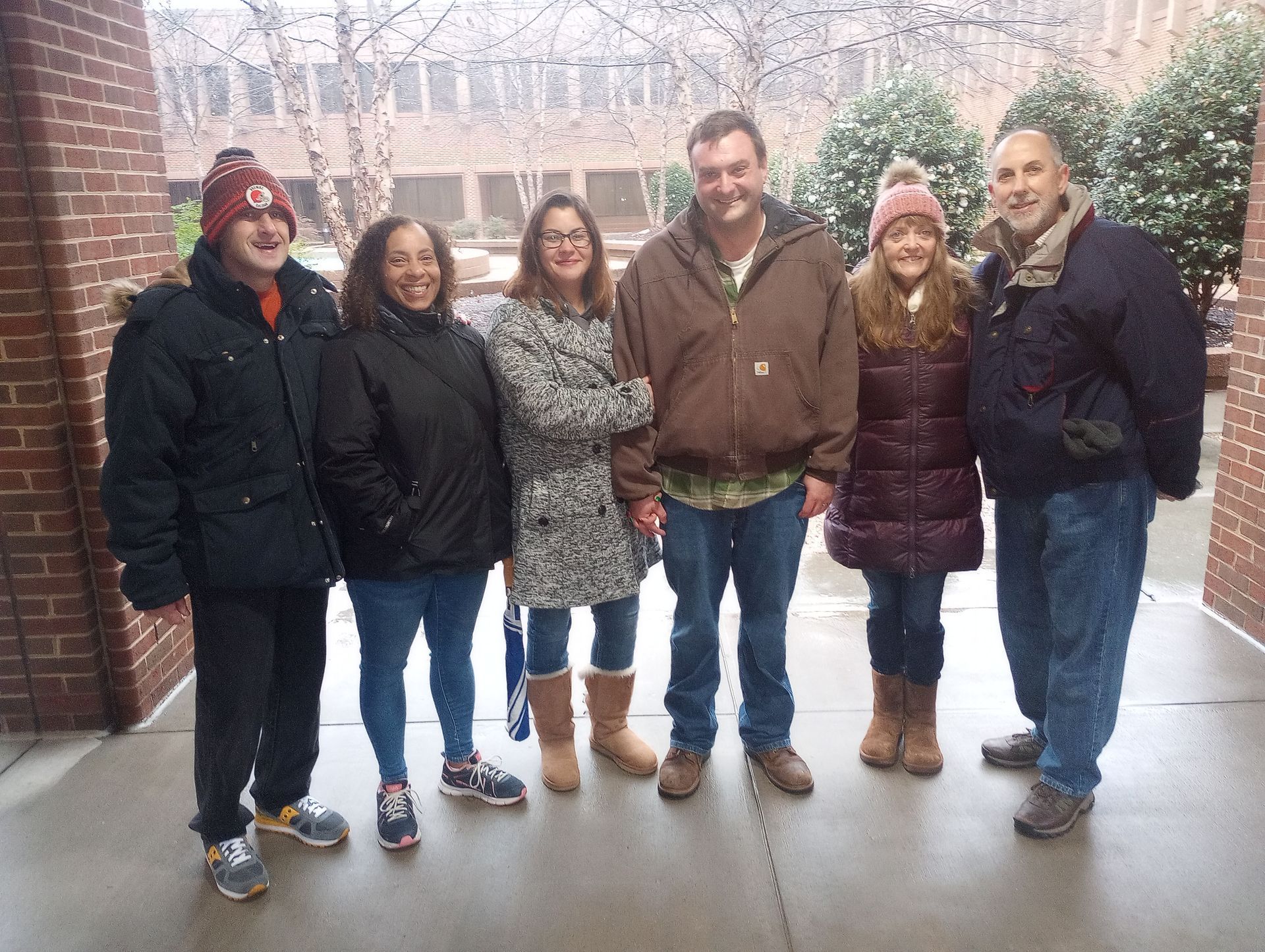 A group of people standing in front of a brick building